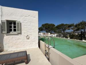 a house with a swimming pool next to a building at 3 Bd Stonehouse with Swimming Pool in Paraspóri