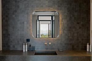a bathroom with a sink and a mirror at Villa Orama Corfu in Karyótikon +64 photos