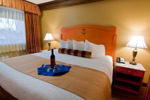 a hotel room with a bed with a bottle of wine on it at Abercorn Hotel, Trademark Collection by Wyndham in Richmond