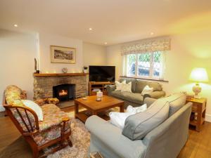 a living room with a couch and a fireplace at The Chimes in Castleton