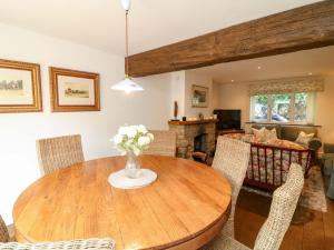 a living room with a wooden table and chairs at The Chimes in Castleton