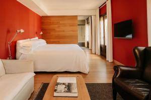 a hotel room with a bed and a couch at Casa Camper Barcelona in Barcelona