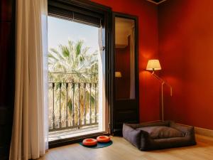 a living room with a large window and a couch at Casa Camper Barcelona in Barcelona