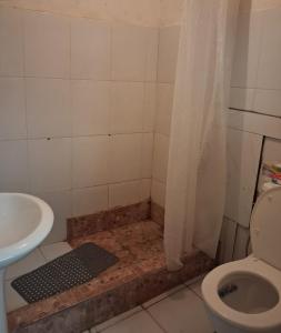 a bathroom with a shower with a toilet and a sink at Porto Calheta in Calheta