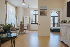 a living room with a kitchen and a dining room at Next Apartments Constanta in Constanţa