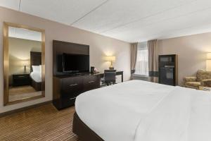 a hotel room with a large bed and a television at Comfort Inn Lehigh Valley West in Fogelsville +31 photos