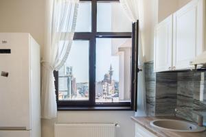 a bathroom with a window with a view of a city at Next Apartments Constanta in Constanţa +71 photos