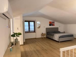 a bedroom with a bed and a potted plant at Markylian House in Castiglione del Lago +44 photos