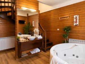 a bathroom with a large tub and a sink at Ioana Boutique Hotel in Sinaia +102 photos