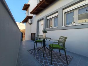 a patio with a table and chairs on a balcony at Argiros Apartments in Kefalos