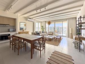 a kitchen and living room with a table and chairs at Marassi Marina Views At BirdNest in Sīdī ‘Abd ar Raḩmān