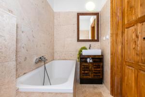 a bathroom with a tub and a sink at Resort Biskupský Dvůr in Višňová +16 photos