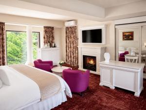a hotel room with a bed and a fireplace at Ioana Boutique Hotel in Sinaia