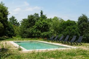 a swimming pool with lounge chairs and a swimming pool at CA L'HERBOLARI - Cozy house in Montseny in Viladrau