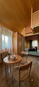 a woman laying on a bed in a room at Livada Bunicilor in Zamfireşti