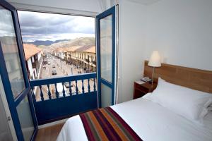 Postel nebo postele na pokoji v ubytování Hotel Plaza de Armas Cusco