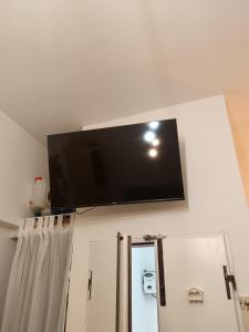 a flat screen tv hanging on a wall at Casa Cavour 15 in Porto Santo Stefano