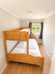 two bunk beds in a small room with a window at Lillehammer Camping in Lillehammer
