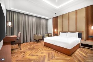 a hotel room with a bed and a desk at Northern Residency in Srinagar