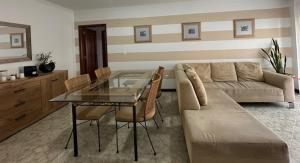 a living room with a table and a couch at Praia - Mar in Ovar