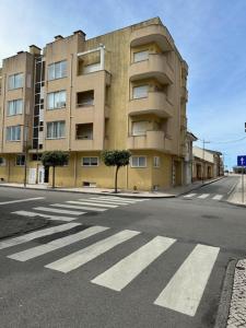 an empty street in front of a building at Praia - Mar in Ovar