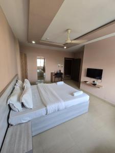 a large bedroom with a large white bed with pillows at SILVER REGENCY in Guwahati
