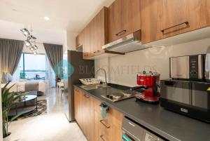 a kitchen with a red coffee machine on a counter at Bloomfields Studio in Oasis Masdar in Abu Dhabi