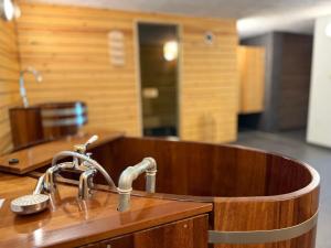 a wooden tub with a sink in a room at Baron in Beffe