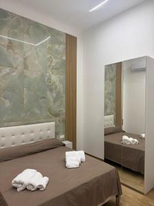 a bedroom with two beds and a large mirror at Largo Sicilia B&B in Avola +45 photos