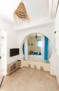 a bedroom with a bed and a tv in a room at Dar Ahlem Djerba in El Guecheïne
