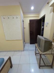 a tv sitting on a table in a room at Hotel Geetanjali in Lucknow