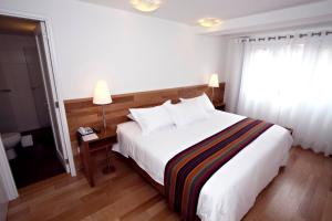 Postel nebo postele na pokoji v ubytování Hotel Plaza de Armas Cusco