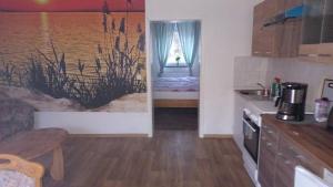 a small kitchen with a bed in a room at Gramelowersee in Teschendorf +15 photos
