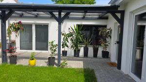 a patio with potted plants on a house at Martin Ferienhaus in Burg bei Magdeburg