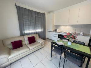 a living room with a couch and a table at Balerna Swiss Apartment by RentuGoo Travel in Balerna