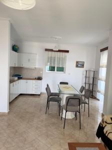 a kitchen and dining room with a table and chairs at Hotel Vila Kafe in Lukovë +79 photos