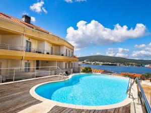 a hotel with a swimming pool and a view of the water at Hospedium Galitrips Airexa in Corcubión