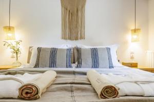 a bedroom with a bed with two pillows on it at Casa Gaia in Panormos Skopelos