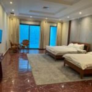 a large room with two beds and a table at منتجع اليال Alyal Resort in Al Khīrān +66 photos