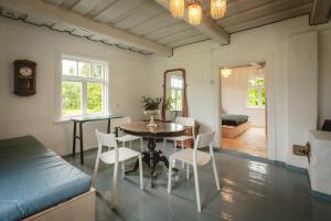 a kitchen and dining room with a table and chairs at Retreat House in Lauvas