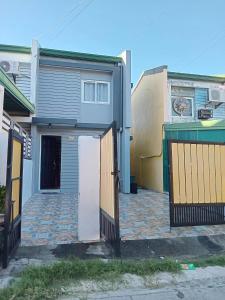a house with a gate in front of it at 3G's & C Transient House Calapan in Camilmil +6 photos