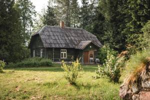 an old house in the middle of a field at Retreat House in Lauvas