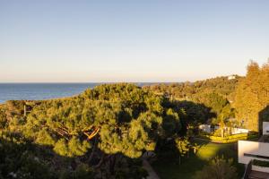an aerial view of a garden with the ocean in the background at Grand Hotel Du Golfe - Spa & Restaurant in Collioure