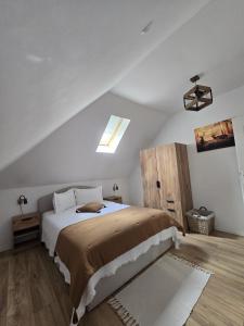 a bedroom with a large bed in a attic at Casă chic La Han la Slănic in Slănic-Moldova