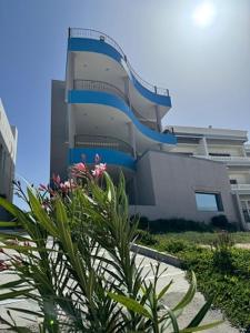 a building with a staircase in front of it at منتجع اليال Alyal Resort in Al Khīrān
