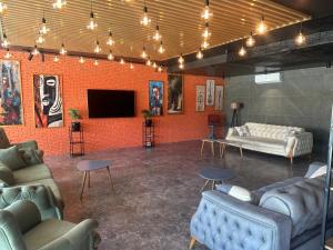 a living room with couches and a flat screen tv at Aparthotel costa in Makhinjauri