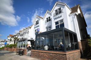 a white building with glass windows in front of it at Camelia Hotel in Southend-on-Sea