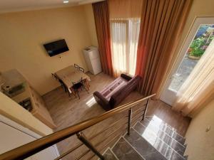 an overhead view of a living room with a couch and a table at cozy wave house ureki in Ureki
