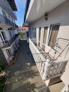 a balcony of a building with a white railing at cozy wave house ureki in Ureki +1 photo