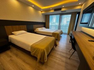 a hotel room with two beds and a television at VOLLEY HOTEL ANKARA in Ankara +10 photos